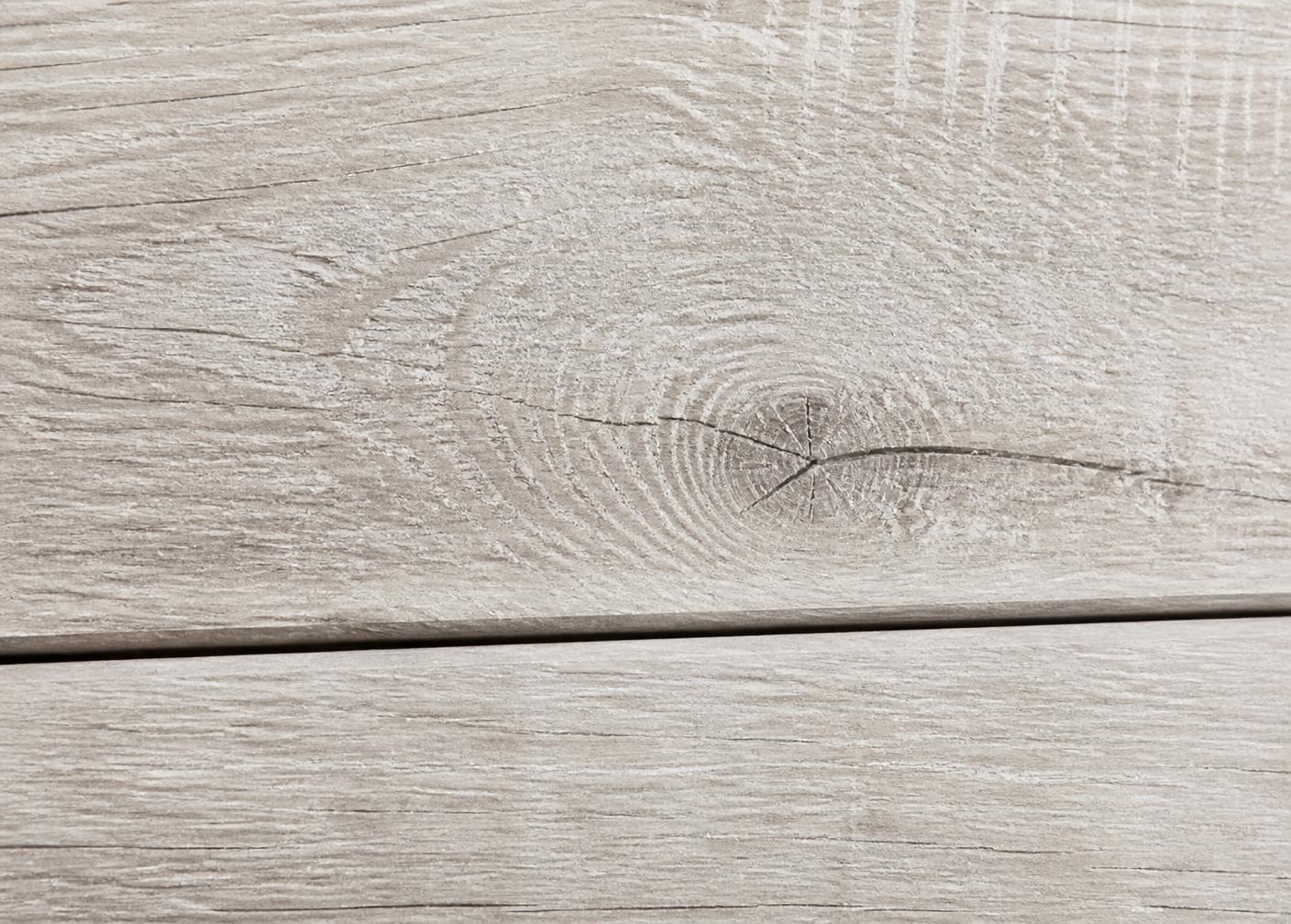 Close detail of oak plank grain and micro-bevel edge in raking daylight