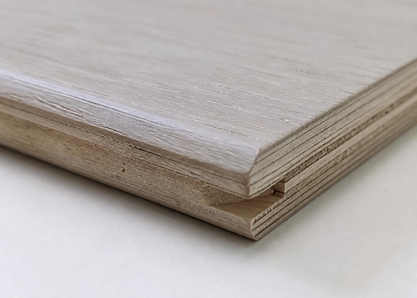 Edge of an engineered oak plank showing the multi-ply core under neutral daylight