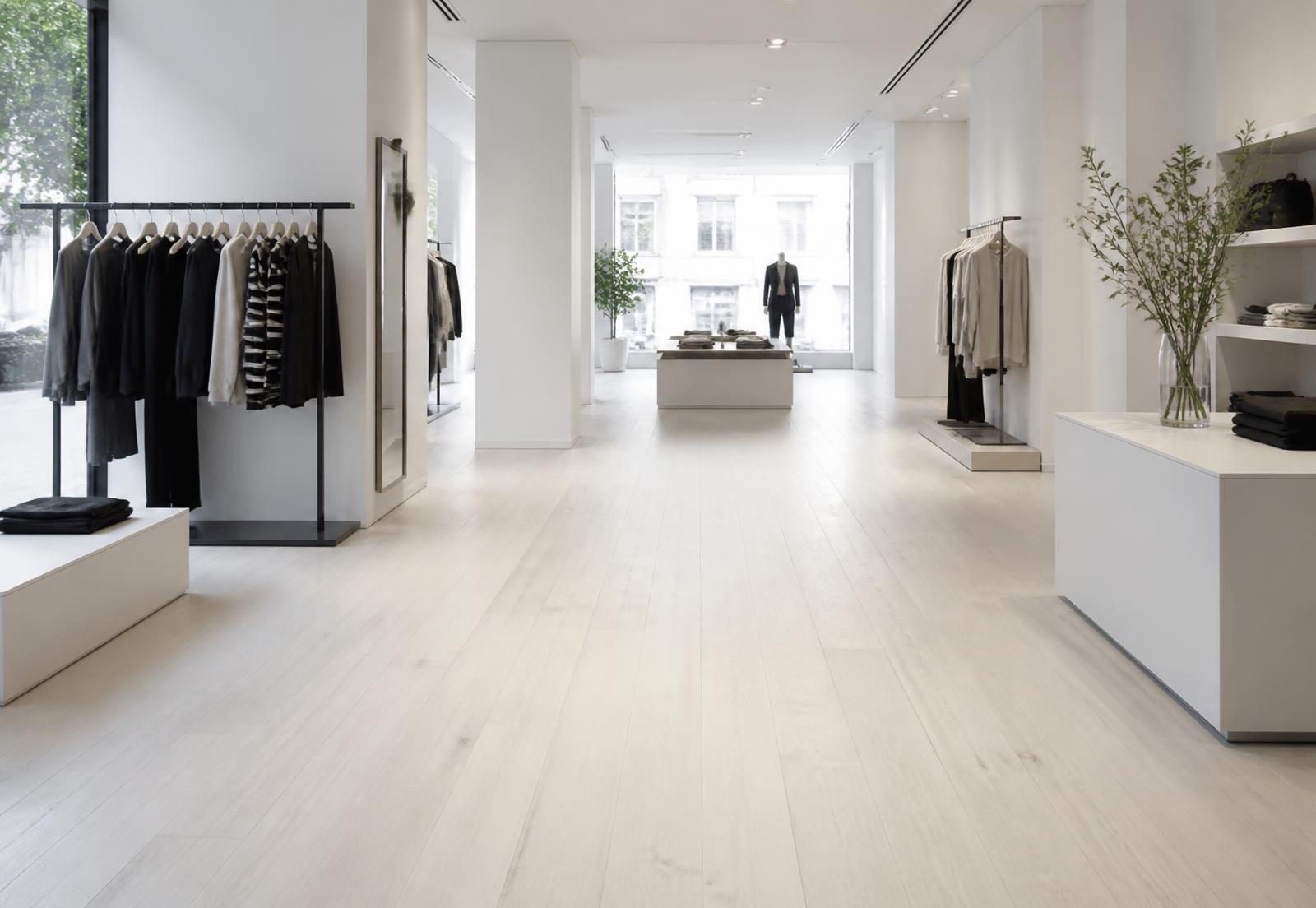 Boutique retail interior with a pale oak plank floor and daylight from the shopfront